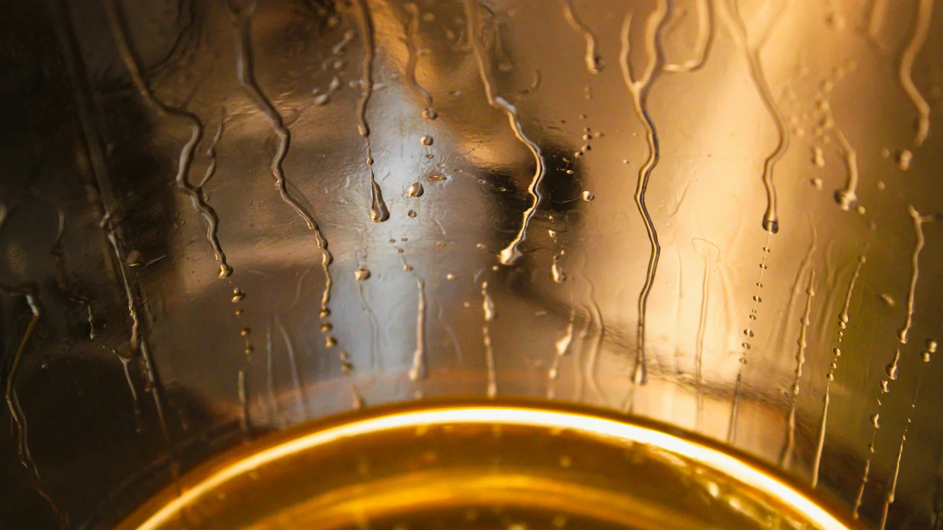 Biergarten rund um Königsbrunn gesucht? Wassertropfen laufen an der Innenseite eines beleuchteten Glases hinab